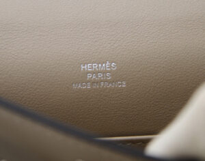 Hermès Kelly Pochette Trench en cuero Swift con herrajes de paladio – bolso de lujo elegante en beige - stamp